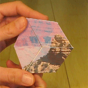 Two hands holding a transparent block with a mountain inside.