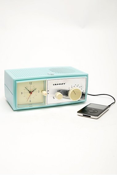 A midcentury clock with a a phone charger