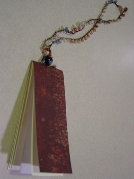 A red notebook on a chain.