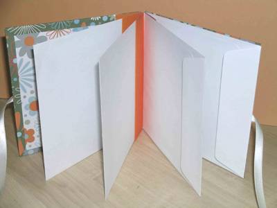Decorative, and white envelopes are bound together to make a journal.
