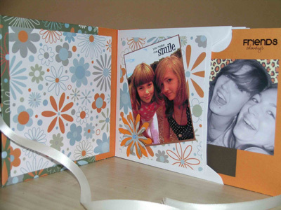 A card with flowers and pictures of girls.