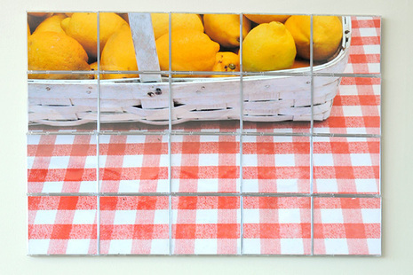 Picture of a basket of lemons on a checkered table cloth.