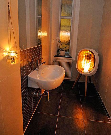 A bathroom that has a sink, as well as a flameless fire.