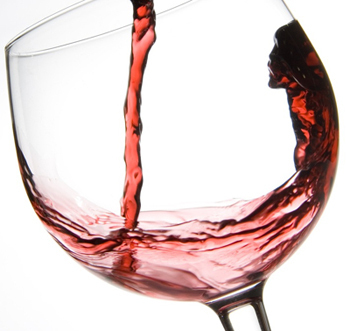 Red wine being poured into a glass.