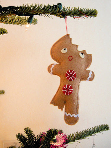 Ornament of a Gingerbread cookie that has bites out of it.