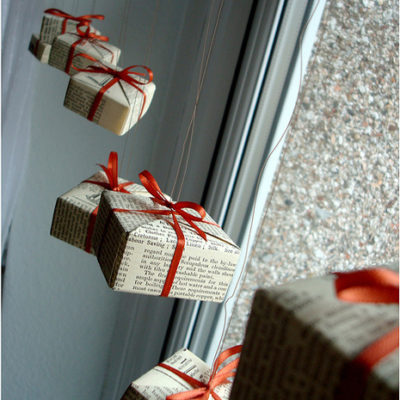 A series of newspaper wrapped presents hung as decorations.