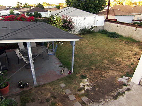 An overhead view of a dilapidated open enclosure patio.