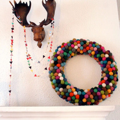 A moose head on the wall, with a large donut on the side.