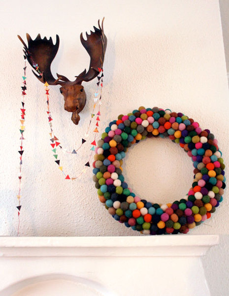A moose head on the wall, with a large donut on the side.