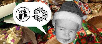 Baby making a face at the huge amount of wrapping paper on the ground.
