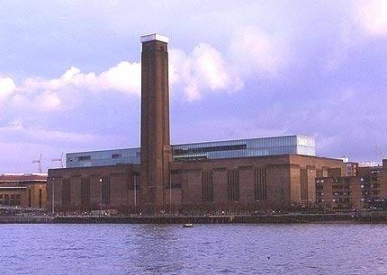 Large brick building on the edge of a harbor.