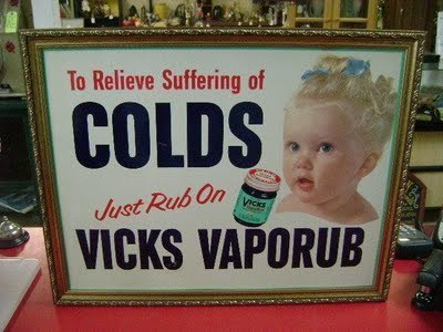 A framed picture of an old Vicks vapor rub advertisement.