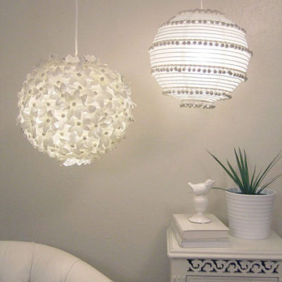 Two, white, decorative hanging globe lamps.