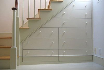 A set of white steps with a series of drawers build into the underside.