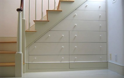 A set of white steps with a series of drawers build into the underside.