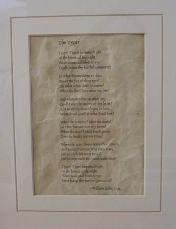 An old piece of paper in a white frame with a poem written on it.