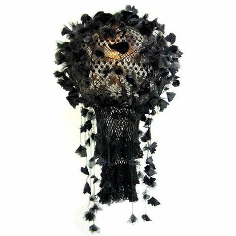 A black hat with tassels hanging all over.