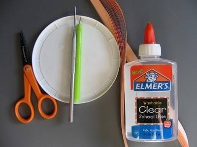 A clear glue gel is sitting next to scissors and tools.