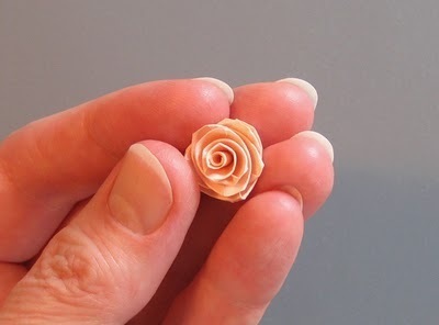 Person holding a small paper rose.