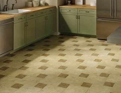 A kitchen with olive cabinets and a tan and brown checkered floor.