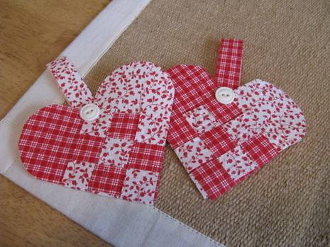 Paper hearts are woven out of paper or cloth and have hanging loops and button closures.