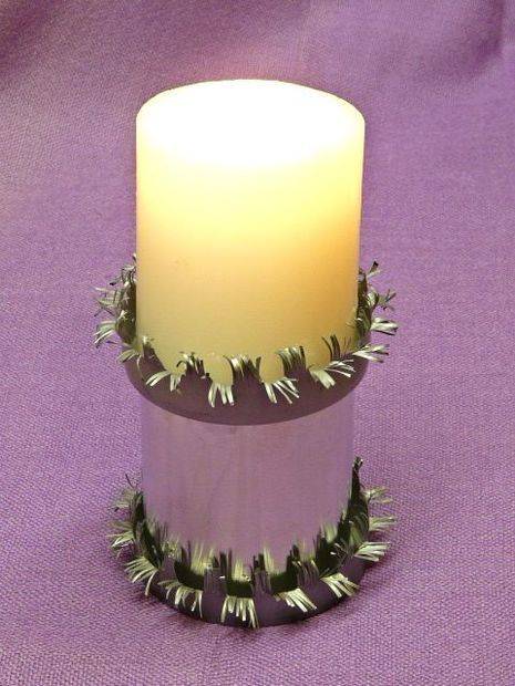 A vanilla candle inside of a Christmas looking holder.