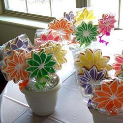 Potted plant holders with colorful fake flowers in them.