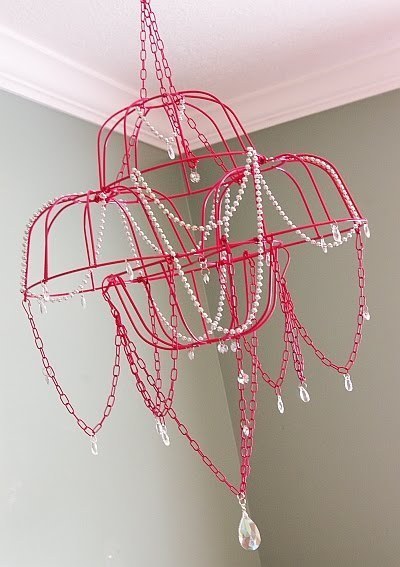 A large red chandilier hangs in a room.