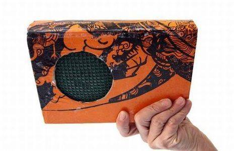 A car subwoofer with an orange and black design.