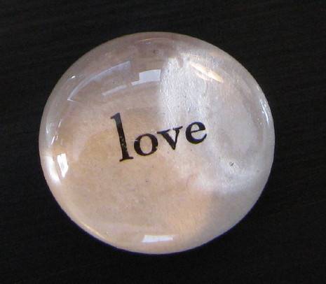 Love is written on a white circular object.