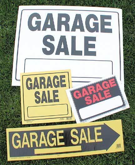 A collection of white, red and yellow garage sale signs.