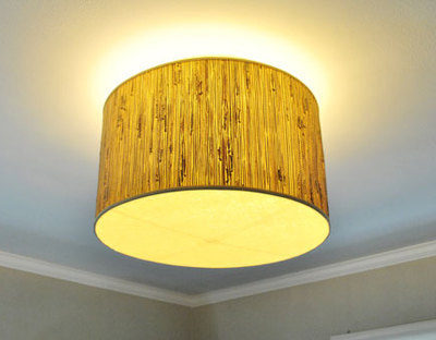 A flush ceiling light fixture with a brown textured shade