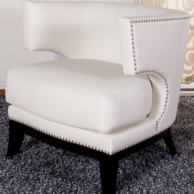 A white chair with a black base sits on the floor.