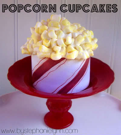 Popcorn sits in a red and white container on a red platter.