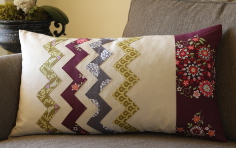 Homemade throw pillow with different patterns of fabric.