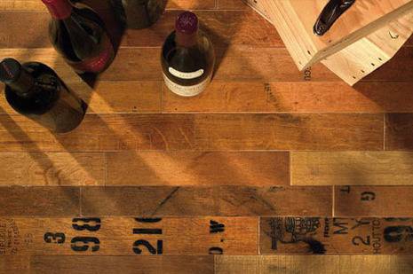 Wine bottles on barrel floor.