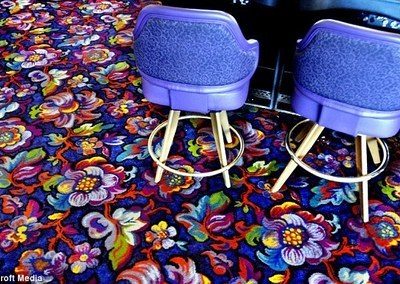 Vibrant carpet has a multi-colored floral pattern.
