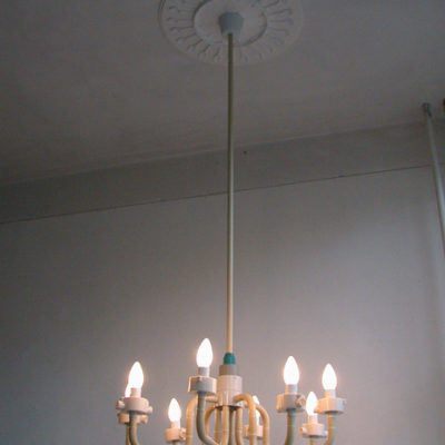 A chandelier with many small bulbs hanging from the roof.