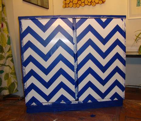 Tape in between each pencil line until the entire cabinet is a taped chevron pattern.