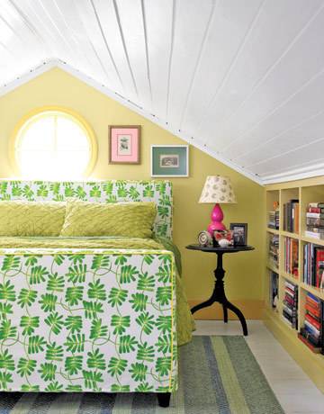 A finished attic bedroom featuring varying shades of green.