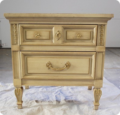 A pale, ornate wooden drawer chest.
