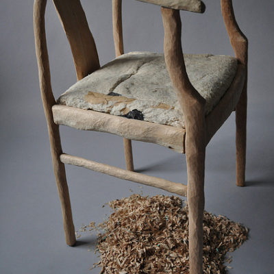 A wooden chair completely hand sculpted.