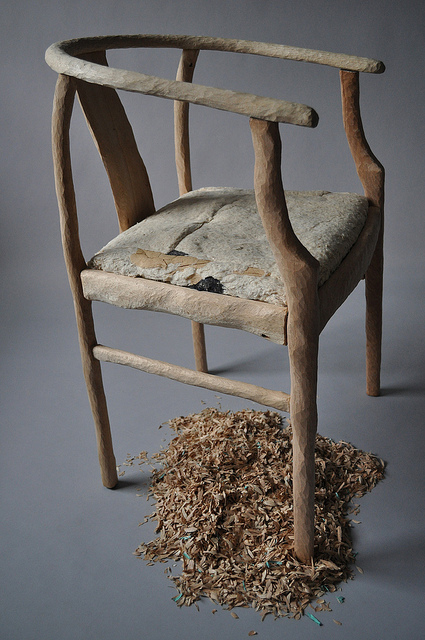 A wooden chair completely hand sculpted.