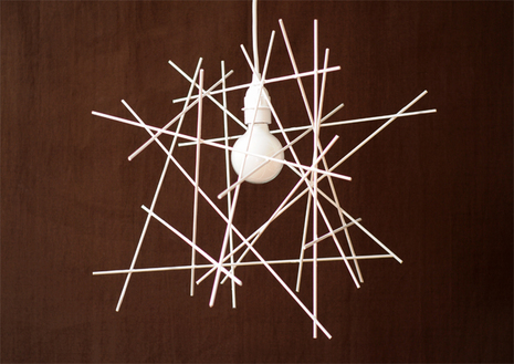 Several white sticks are placed together over a black background.