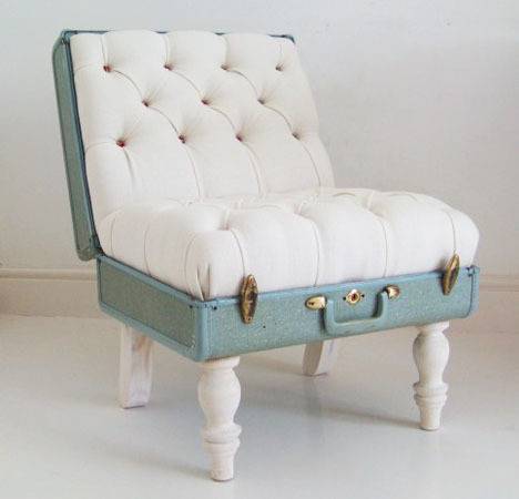 A blue suitcase opend to become a diamond tucked white chair with white legs.