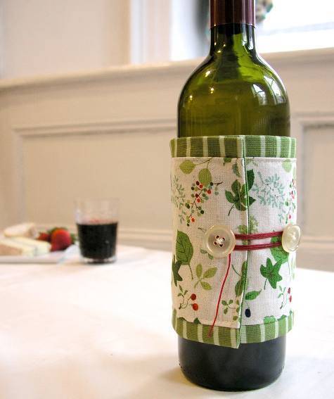 A green colour wine bottle is on the table.