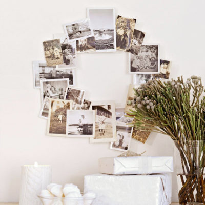White wrapped presents under a circular arrangement of photos.