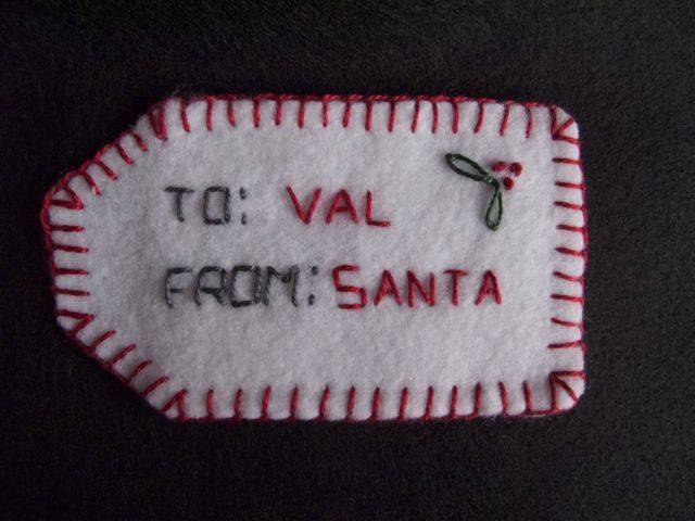 A gift tag that says "To Val from Santa"