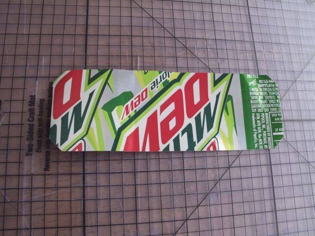 A bookmark made of a strip of an aluminum diet Mountain Dew can.