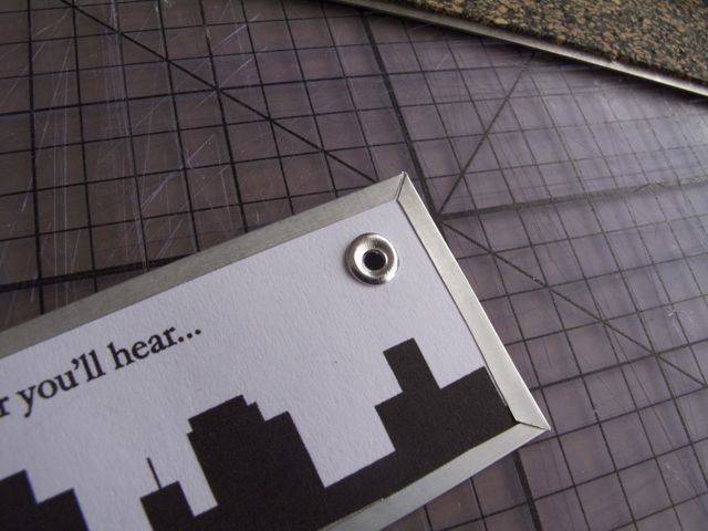 A bookmark with a city skyline in black on white and the words "you'll hear".